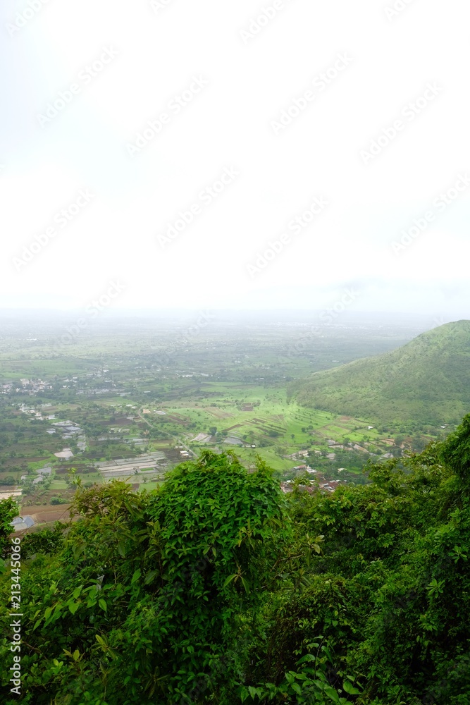 Fototapeta premium Green landscape surrounded by hills, mountains in monsoon season 