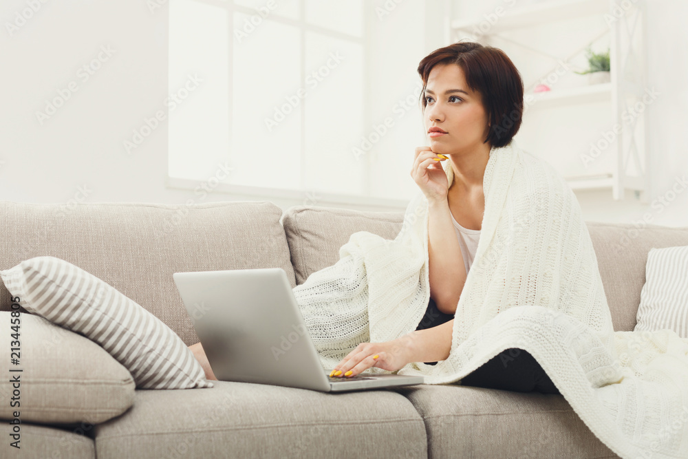 Girl in a blanket working with a laptop Girl in a blanket working with a laptop
