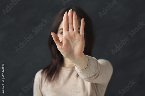 Young woman showing sign stop