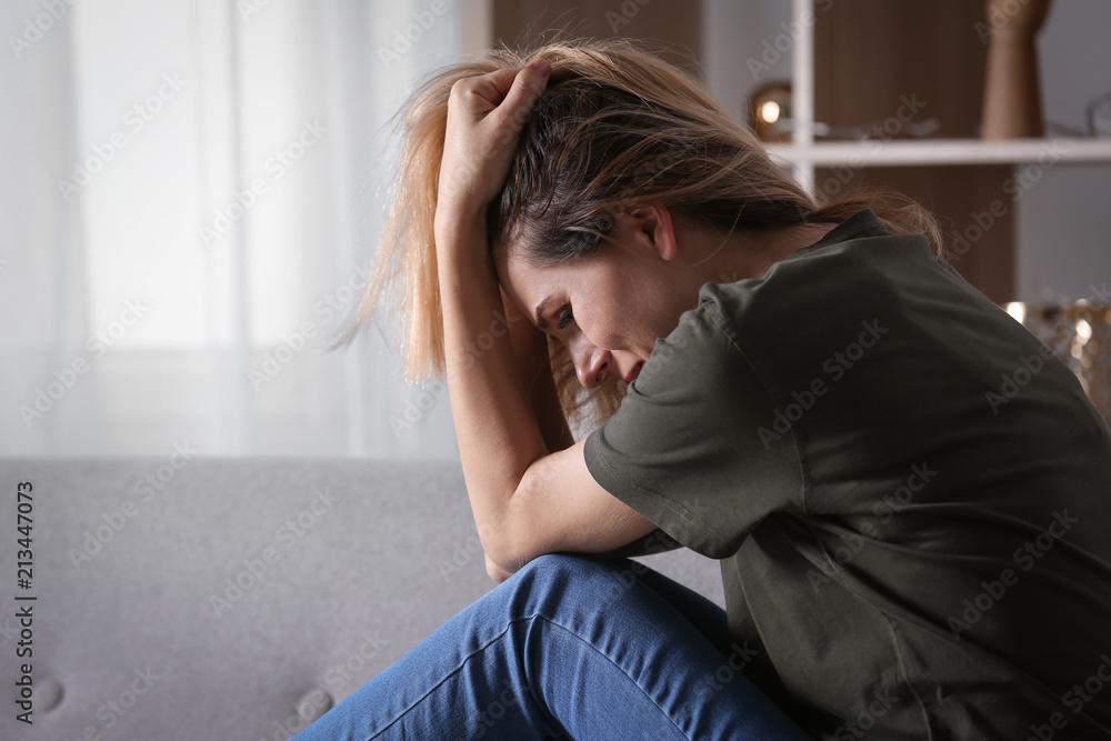 Lonely woman suffering from depression at home Lonely woman suffering from depression at home