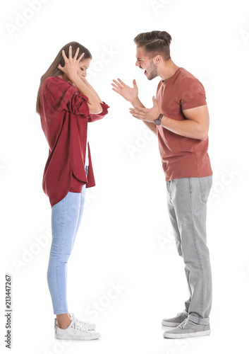 Obraz na płótnie Young couple having argument on white background. Relationship problems