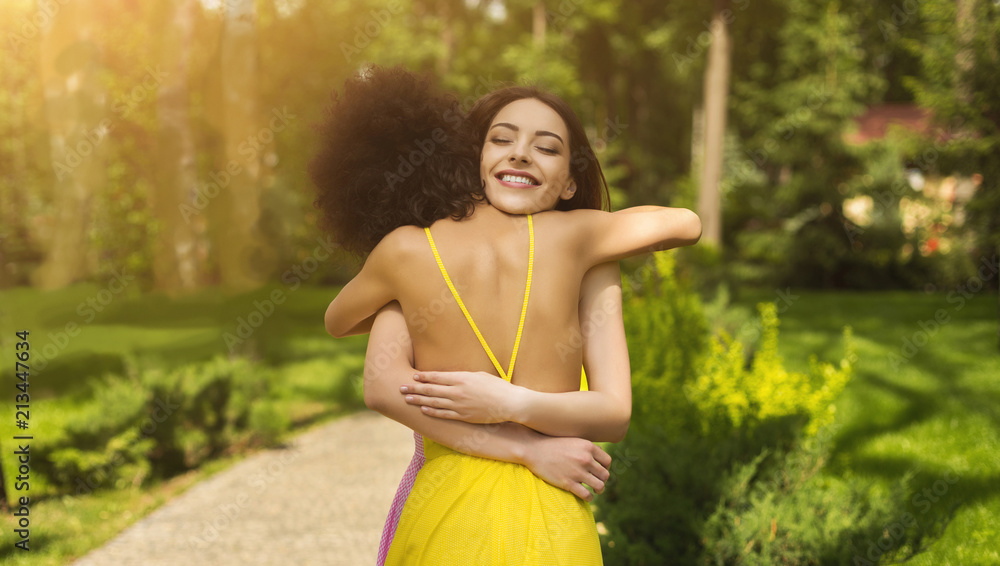 Two happy young girls hug each other outdoors Two happy young girls hug each other outdoors