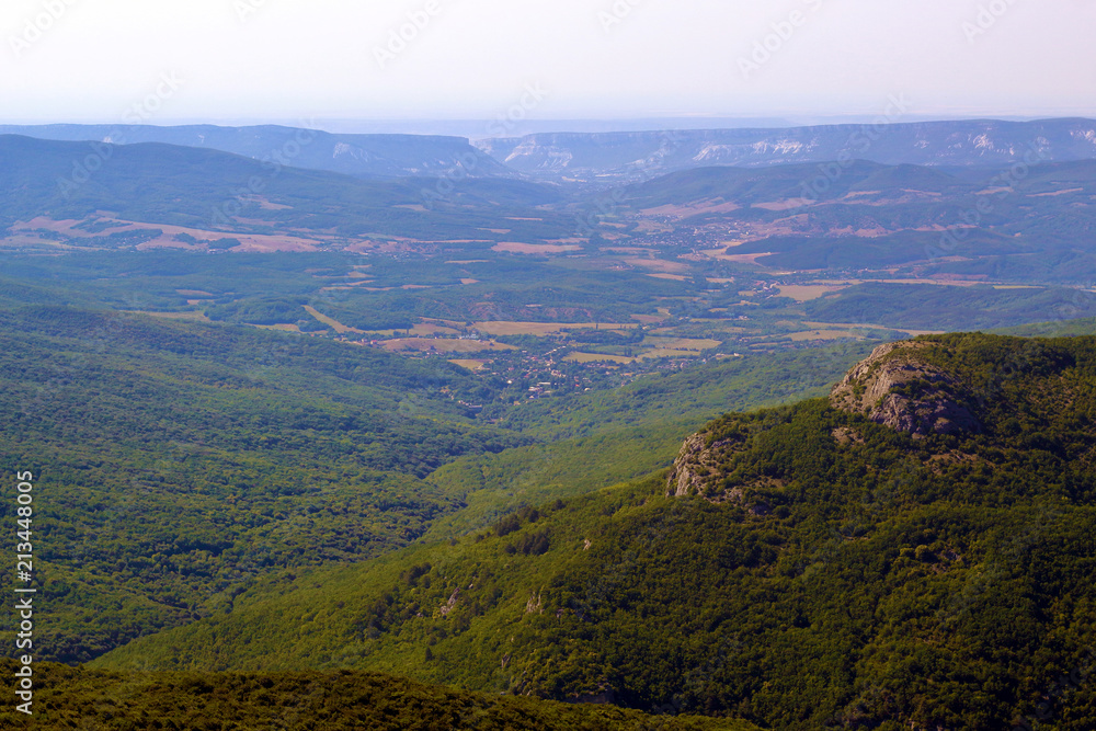 landscape of mountain slopes and trees