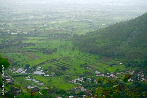 Green landscape surrounded by hills, mountains in monsoon season  © Sandeep