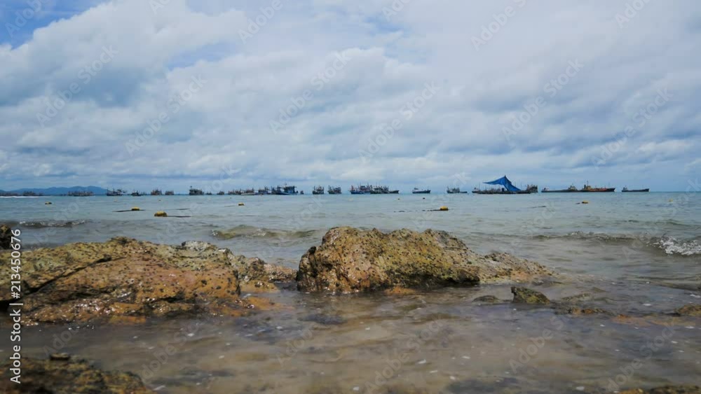 Sea wave with small rock beach with cloudy sky Sea wave with small rock beach with cloudy sky