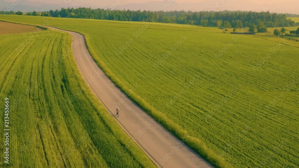 Aerial tracking shot of approaching a single road biker Aerial tracking shot of approaching a single road biker