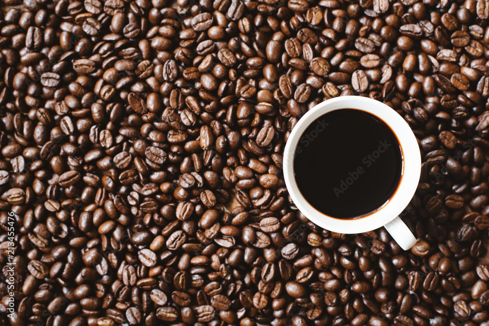 coffee in a cup on coffee beans background. refreshment and favourite drink concept coffee in a cup on coffee beans background. refreshment and favourite drink concept