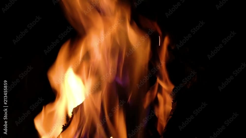 Close up fire burning in the fireplace. Video of fire flames over dark background Close up fire burning in the fireplace. Video of fire flames over dark background