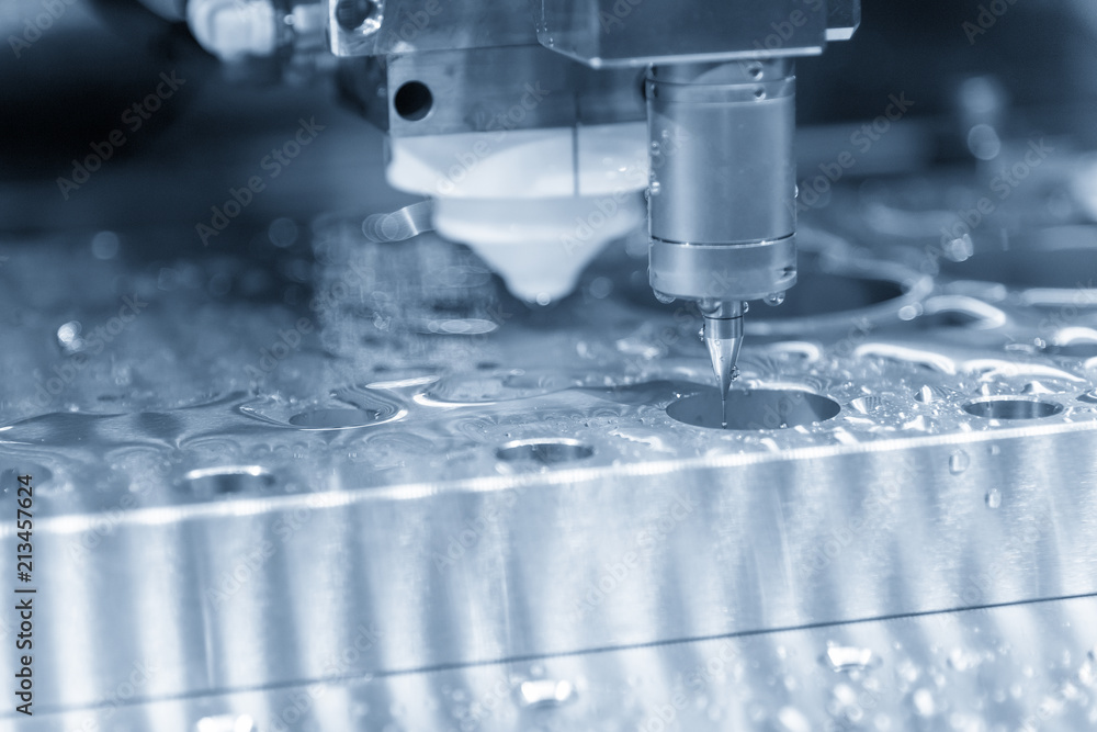 The 3-axis CMM machine measure the wire-edm part in the light blue scene .The quality control system process. The 3-axis CMM machine measure the wire-edm part in the light blue scene .The quality control system process.