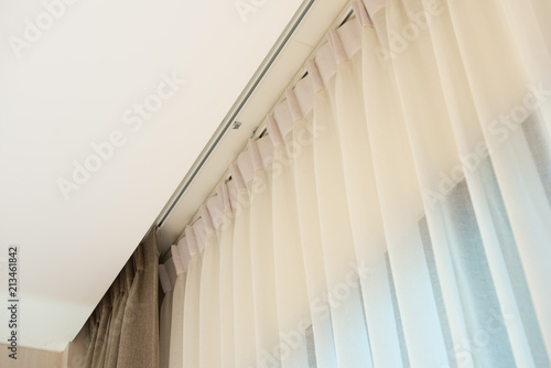 Φωτογραφία Curtain rail with white and brown curtain