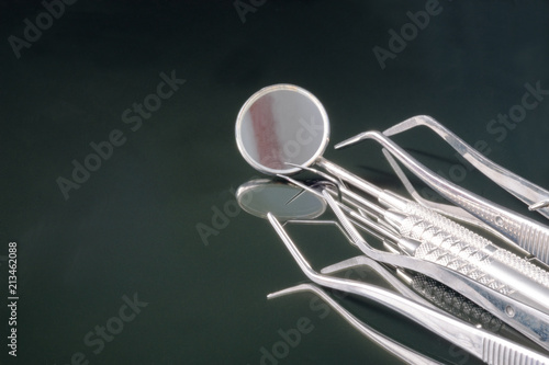 Dental tools use for dentist in the office or clinic. On the black background.