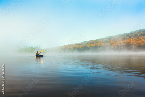 Acive Senior Man Solo Kayaking in Morning photo