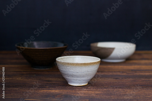 Empty Japanese ceramic bowl on wooden table.