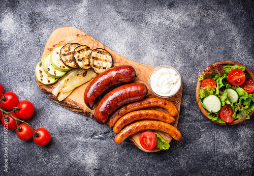 Assortment of grilled sausages and vegetables