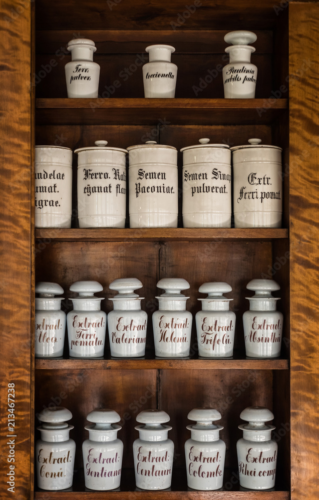 Bottles with medicines on the shelf in old pharmacy. Old pharmacy, medicine and chemistry background.