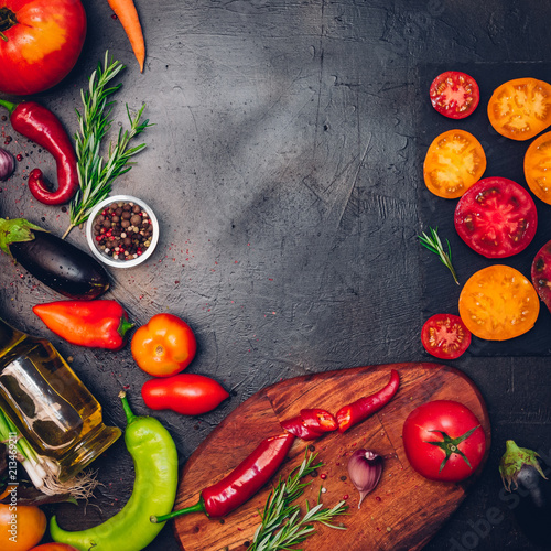 Raw organic vegetables with fresh ingredients for healthily cooking on vintage background, top view, banner. Vegan or diet food concept. Background layout with free text space.