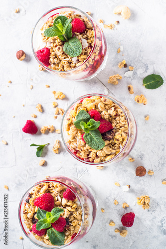 Yogurt parfafait with granola and raspberries top view.