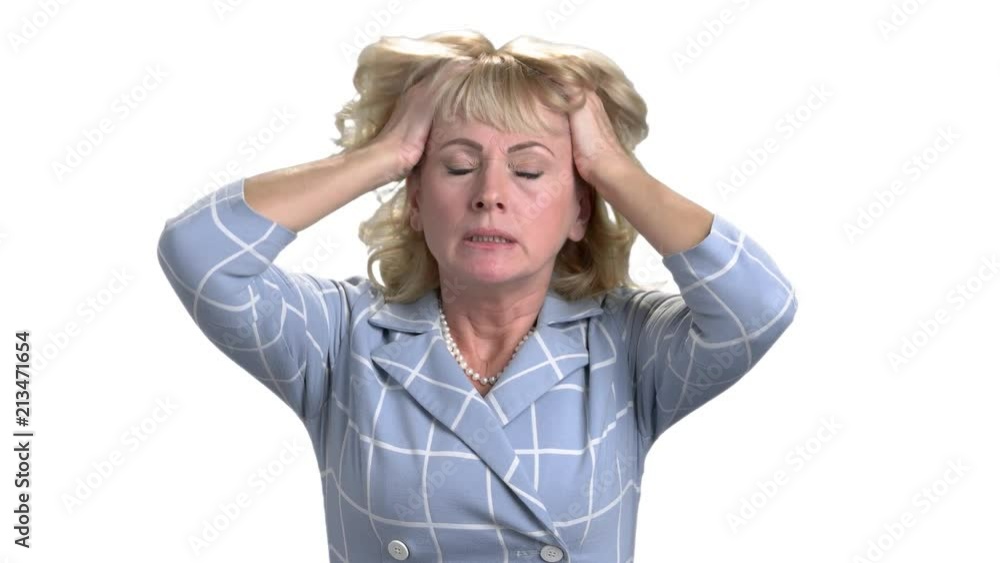 Middle age woman with headache touching her head. Terrible head pain. Extremely tired and stressed mature woman in white isolated background. Middle age woman with headache touching her head. Terrible head pain. Extremely tired and stressed mature woman in white isolated background.