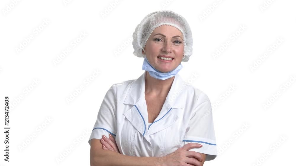 Mature female doctor crossed arms. Happy female surgeon standing arms crossed isolated on white background. Mature female doctor crossed arms. Happy female surgeon standing arms crossed isolated on white background.