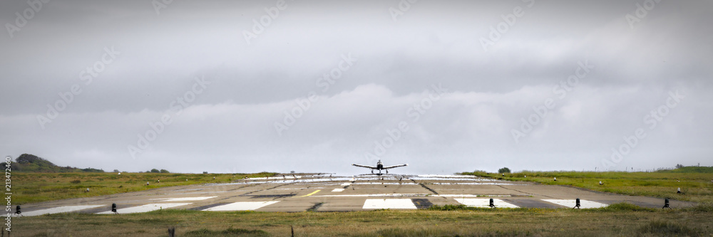 Small airplane takes off LFEY, Yeu Island airfield, France.