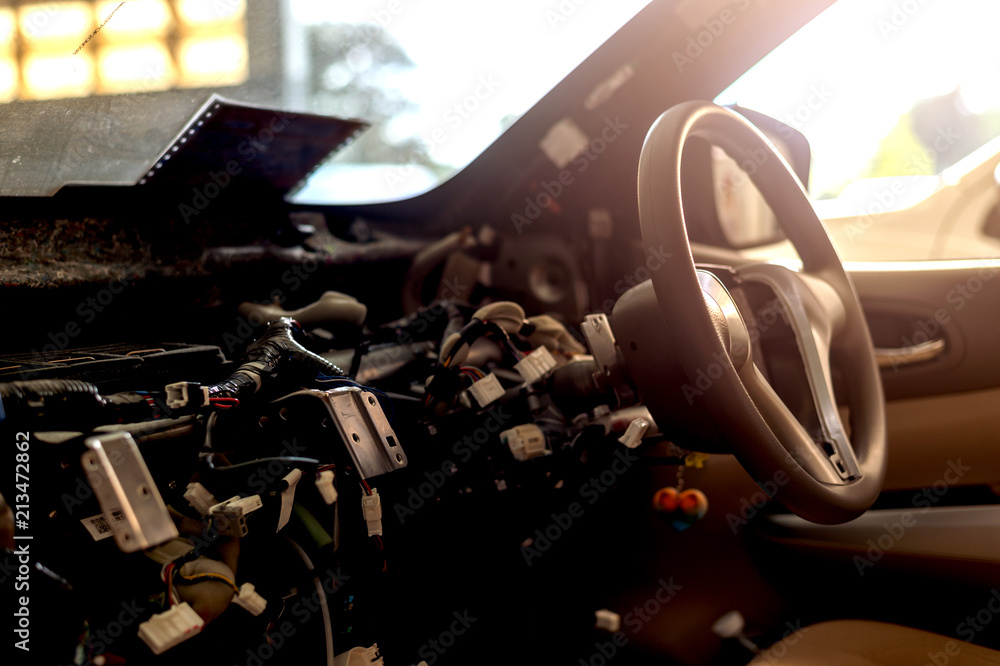 closeup interior in the car steering wheel repair after the accident with soft-focus and over light in the background closeup interior in the car steering wheel repair after the accident with soft-focus and over light in the background