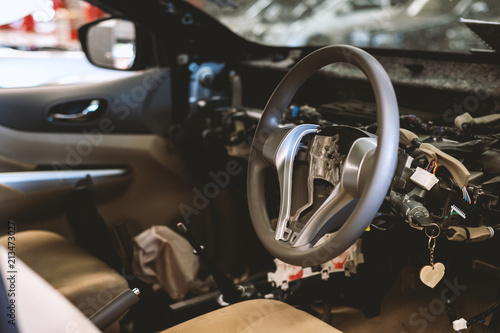 closeup interior in the car steering wheel repair after the accident with soft-focus and over light in the background