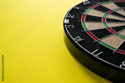 Target dart board on the yellow background, center point, head to target marketing and business concept