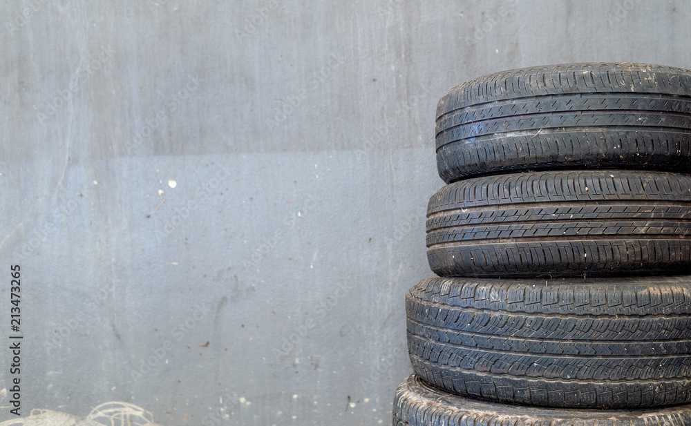 Fototapeta premium closeup old tire car on brick wall