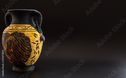 ancient vintage greek vase on black background with space for text