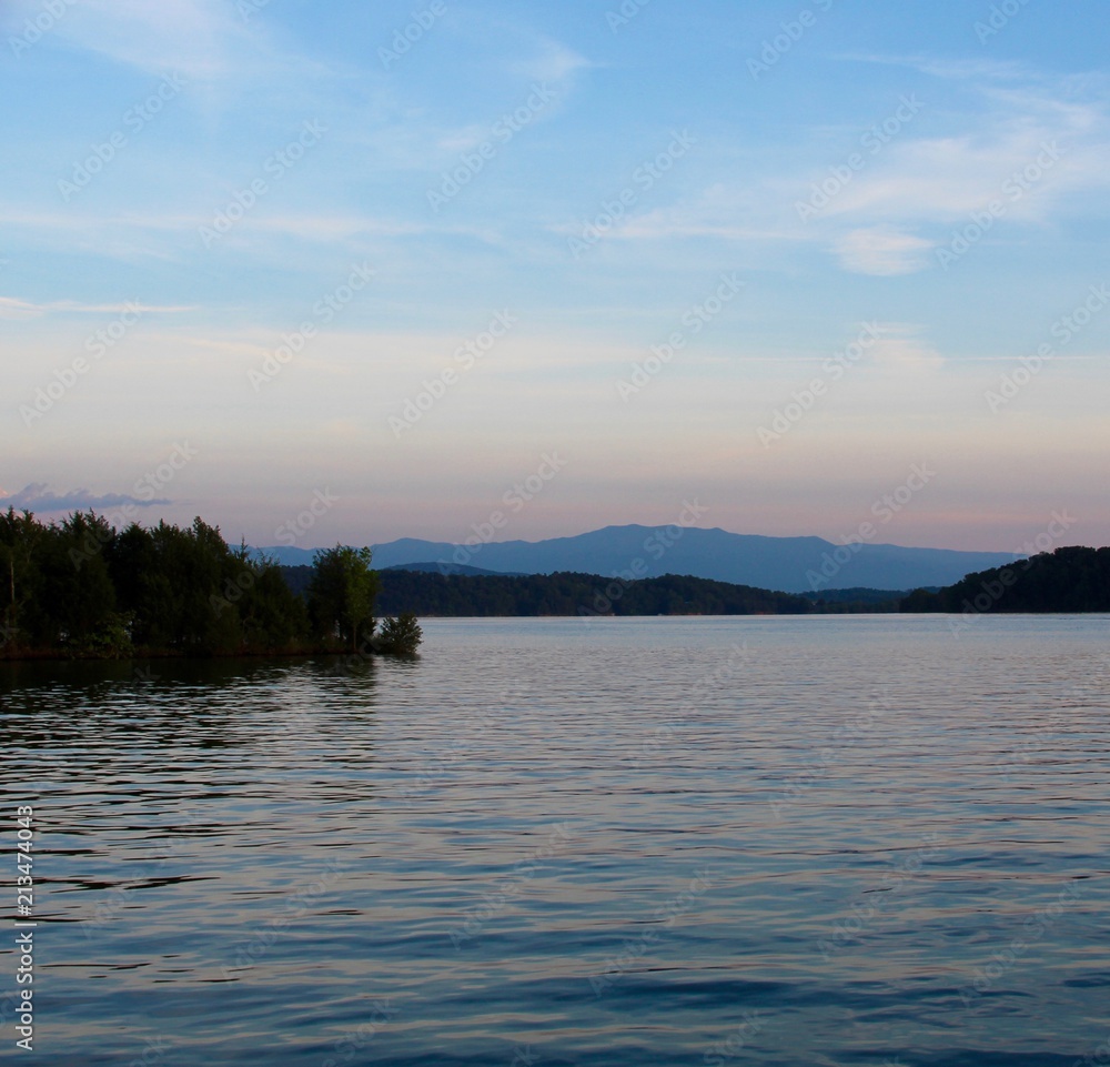 The sunset at the lake with the mountain range in horizon.