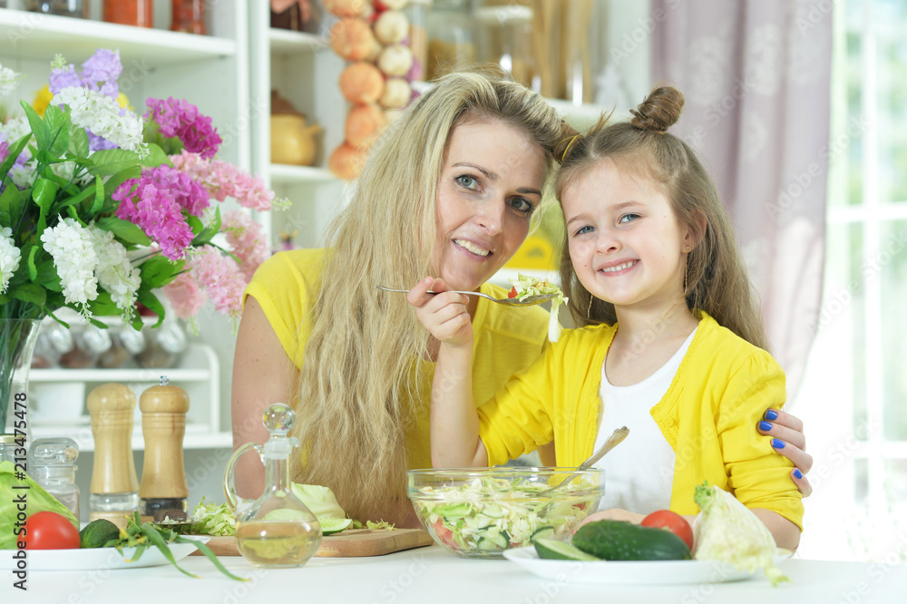 mother and daughter cooking together mother and daughter cooking together
