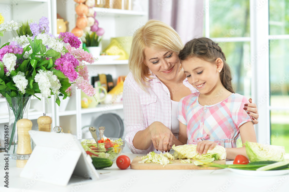 mother and daughter cooking together mother and daughter cooking together