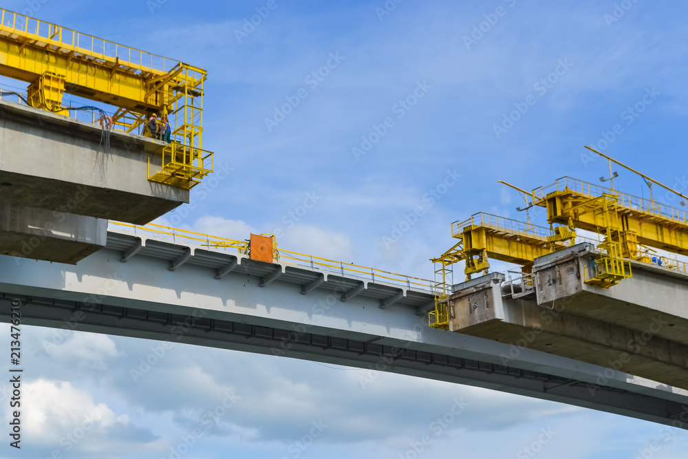 the unfinished part of the road bridge over the river. reconstruction of part of the span, work at height