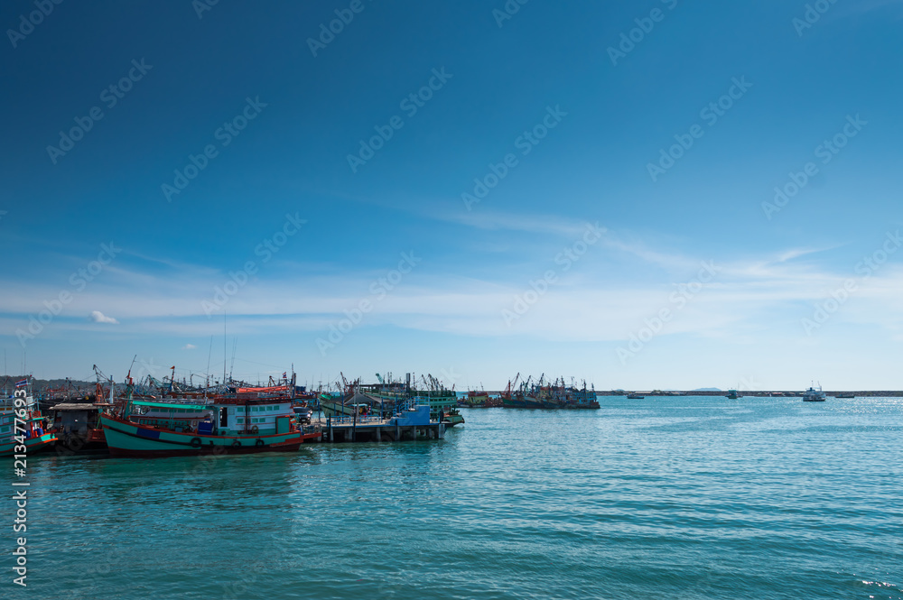 Seascape images , Vivid fresh bright colorful, Beautiful nature of whithe clouds on blue sky And Mane fishing boats are parked at the shore, This place is Ragyong Sea in Thailand