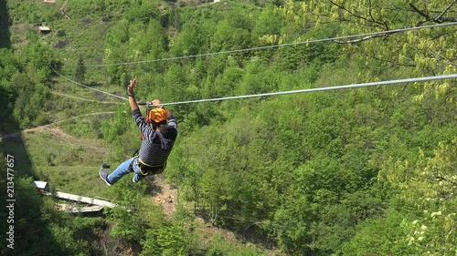 Guy riding on Zip-line over the Tara River. Montenegro