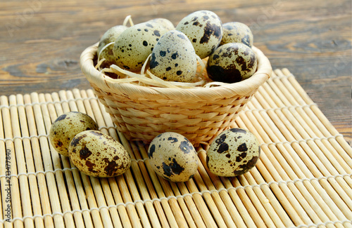 There is an impressively high level of vitamin A found in quail eggs.
Quail eggs in basket with straw on wooden background.