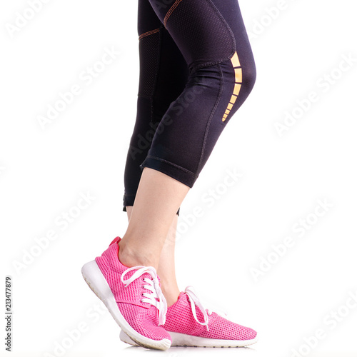 Female legs sports leggings sneakers sports exercises on a white background isolation