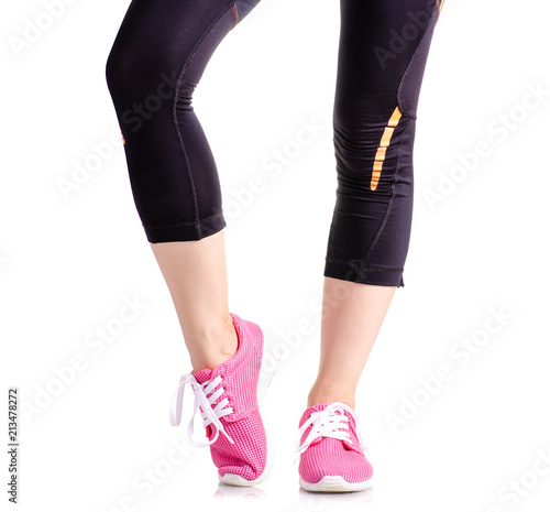 Female legs sports leggings sneakers sports exercises on a white background isolation