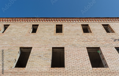 unfinished building with Windows on the background of the blue sky