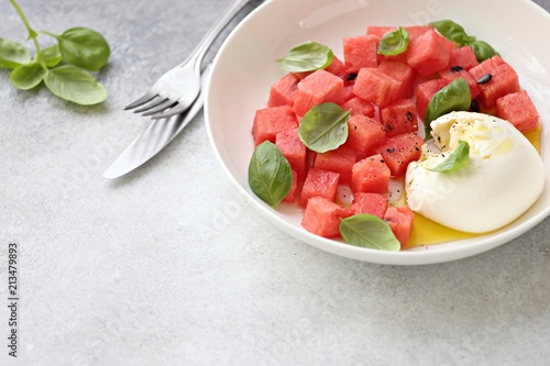 Watermelon Mozzarella Salad with basil and olive oil. Selective focus