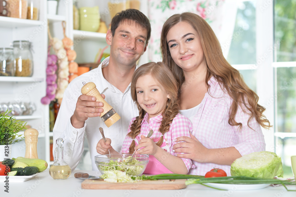 Cute little daughter preparing salad Cute little daughter preparing salad