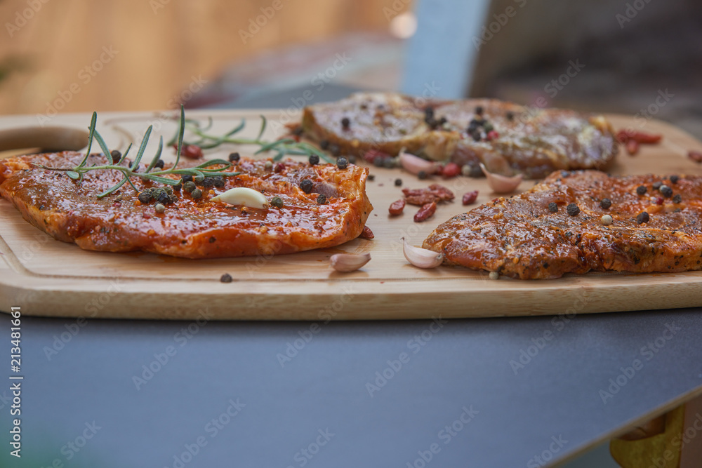 Slices of raw and grilles pork meat Slices of raw and grilles pork meat