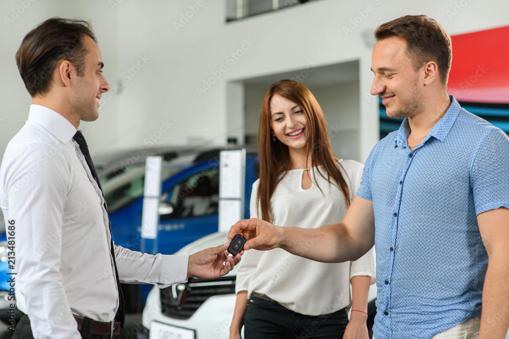 Obraz premium He takes new keys from his brandnew car