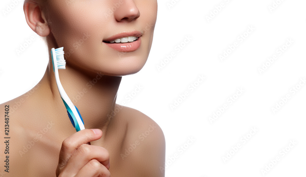 Close-up happy female smile with healthy white teeth, lips makeup. Cosmetology, dentistry and beauty care. Beautiful woman with toothbrush. Dental care background