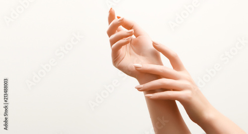 Beautiful Woman Hands. Female Hands Applying Cream, Lotion. Spa and Manicure concept. Female hands with french manicure. Soft skin, skincare concept. Hand Skin Care.