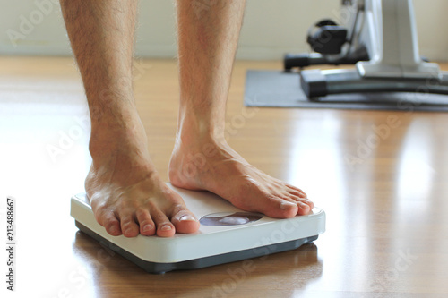 Принти на полотні Male on the weight scale for check weight, Diet concept