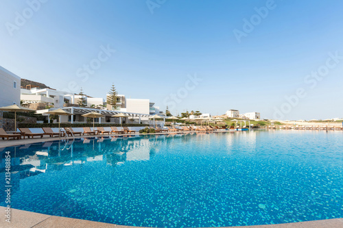 Outdoor hotel swimming pool with sunbeds around © rilueda