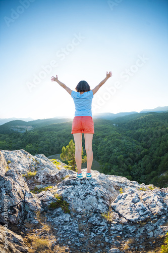 Girl at the top of the mountain. © zhukovvvlad