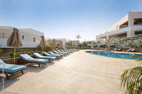 Hotel swimming pool, outdoor, with sunbeds around © rilueda