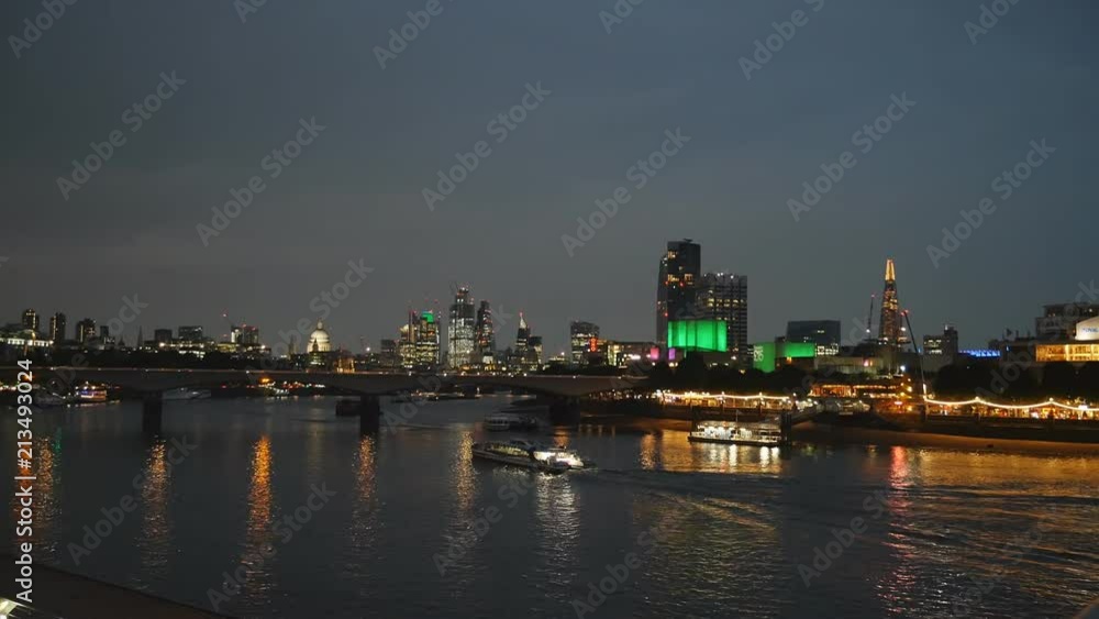 A View of the riverside and a bridge. London at night. A View of the riverside and a bridge. London at night.